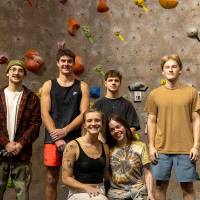 6 of the 7 BYOB champions pose in front of the wall